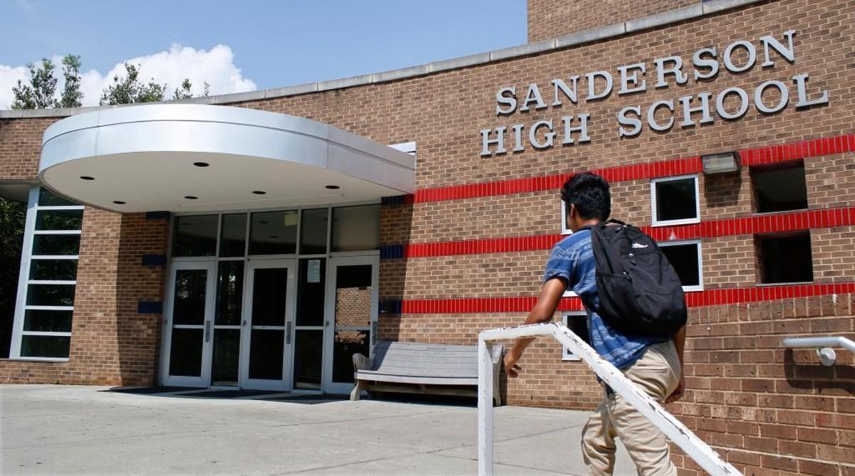 A student walks by the front entrance of Sanderson High School in Raleigh, N.C., in this file photo. Sanderson students were dismissed early on Aug. 28, 2024 due to air conditioning problems.