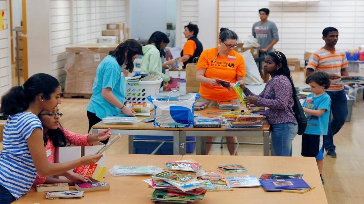 Volunteers sort through some of the over 114,000 books that were collected as part of this year's WAKE Up and Read book drive at a vacant store in the Cary Towne Center on April 9, 2015. Organizers exceeded their goal of collecting 100,000 children's books to give to students at nine high-poverty Wake County elementary schools and community centers near those schools.