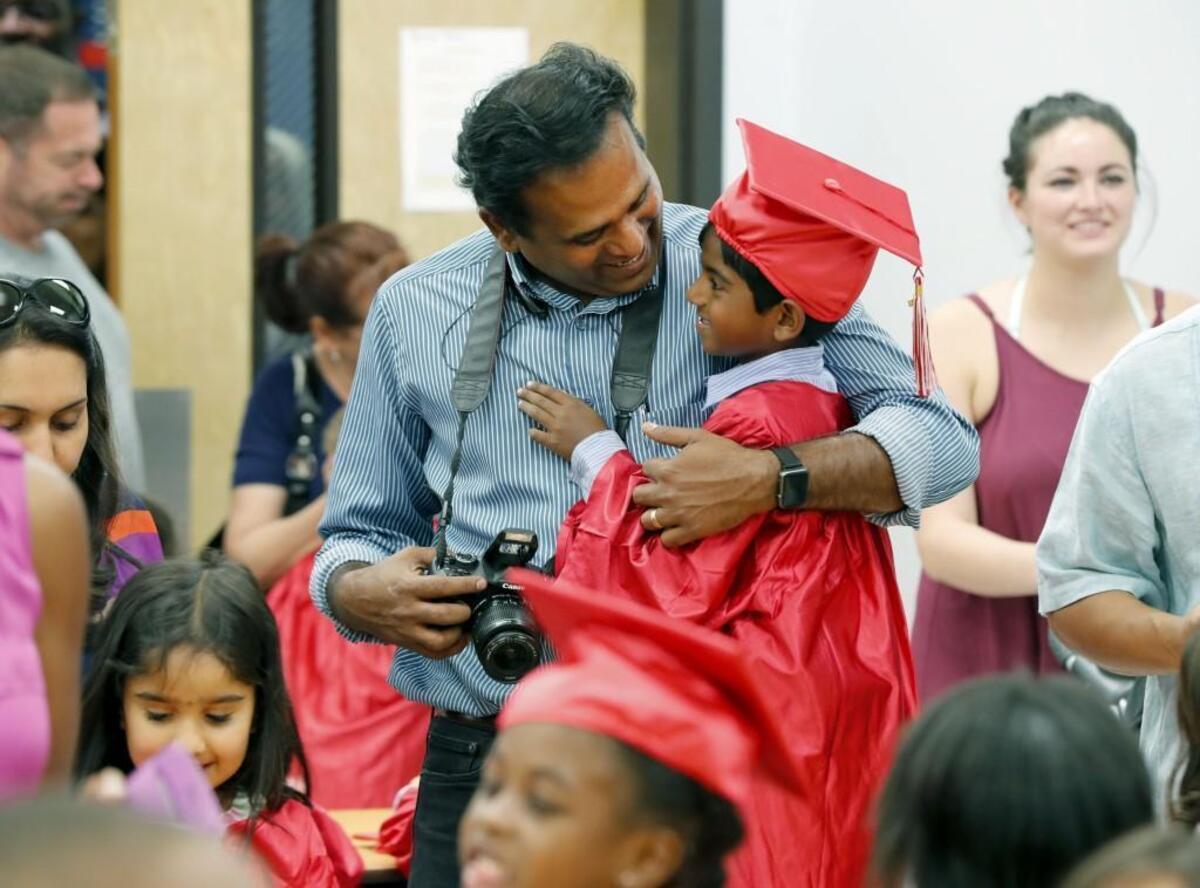 Rishe Syleswaran is hugged by his father Syleswaran Sukumaran after a kindergarten graduation ceremony at the Triangle Math and Science Academy in Cary Wednesday, May 31, 2017.