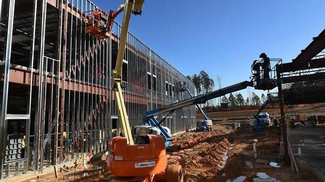 Workers use lifts to work on various areas at Oakview Elementary School in 2015 in Holly Springs.