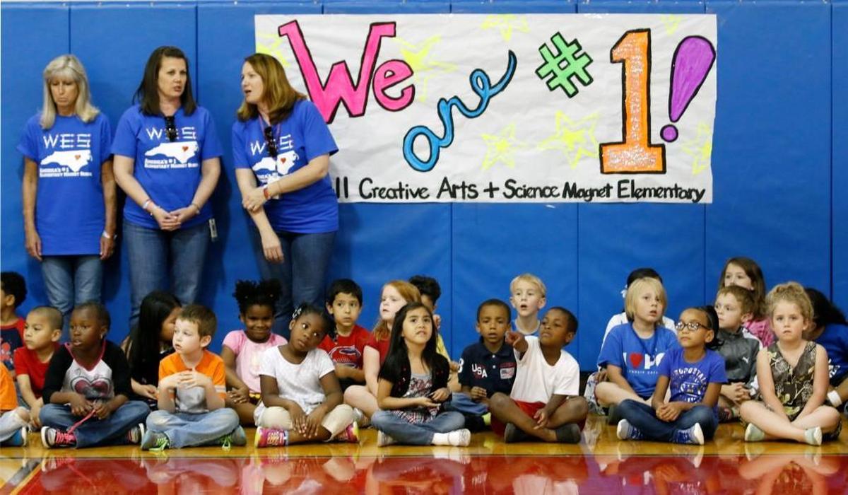 Wendell Elementary Magnet teachers stand with their kindergarten charges, seated just before the start of the awards program and celebration in the school gym on May 15, 2015. Wendell Elementary Magnet was named the Best Magnet Elementary School in the America in 2015.