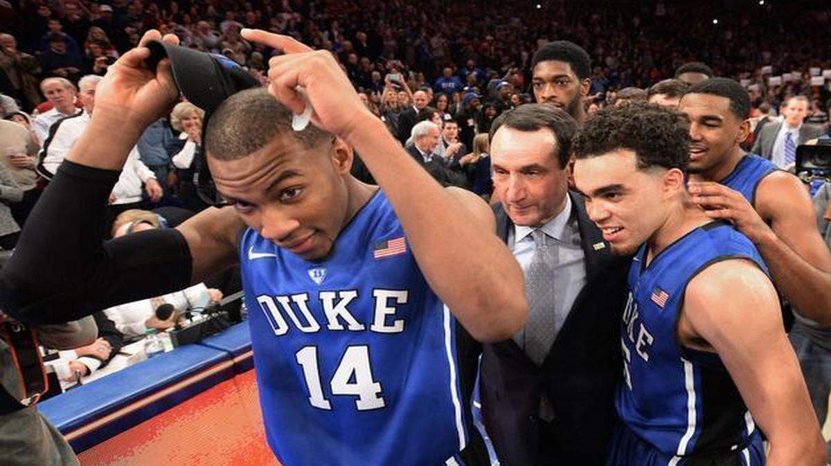 
Duke coach Mike Krzyzewski is surrounded by his players, including Rasheed Sulaimon (14) and Tyus Jones, after the team beat St. John's 77-68 for Krzyzewski’s 1,000th career win on January 25. Four days later, after the team lost at Notre Dame, Sulaimon was dismissed from the team.
