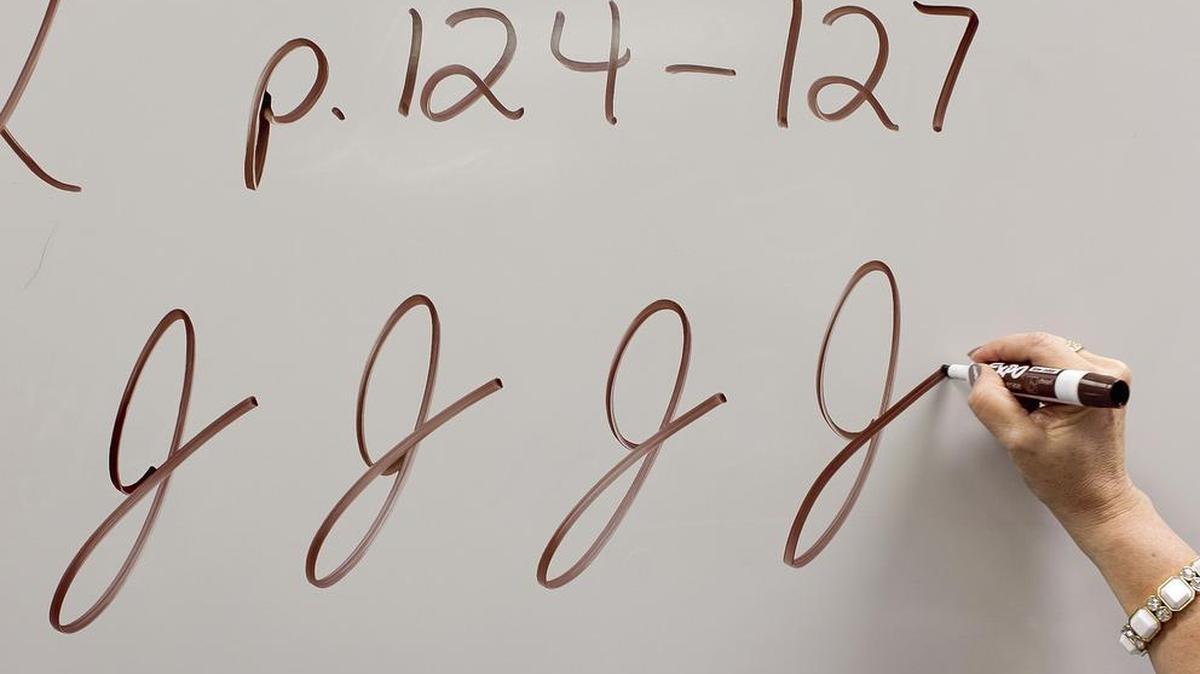 Teacher Cindy Kusilek demonstrates the cursive J in her third grade class at Franklin Academy Charter School on Feb. 22, 2013 in Wake Forest, N.C.