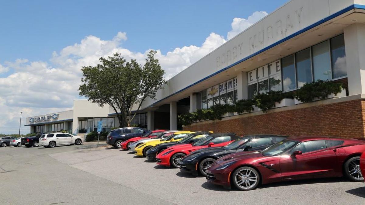 Shiny new Corvettes, right, on the lot wait for buyers at the Capital Chevrolet car dealership, formerly Bobby Murray Chevrolet, on August 17, 2016. The Wake County Public School System recently purchased the property on Capital Blvd inside the 440 Beltline to build a new high school. But the site could temporarily be used to house students from Wiley Elementary School during its upcoming renovation project.