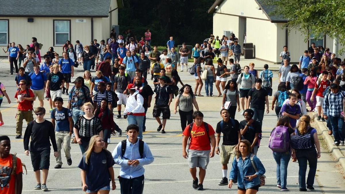 Students at Garner High School walk from modular classroom structures as they change classes. in 2013.