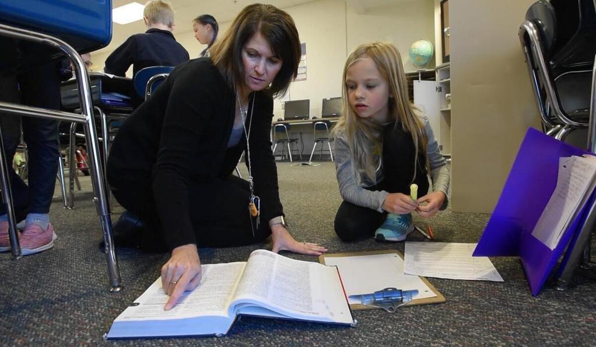 Third-grade teacher Kristi Gutshall works with Keira Fitzpatrick at Holly Grove Elementary School in Holly Springs on Thursday, Nov. 16, 2017.
