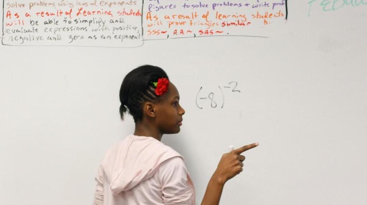 West Millbrook Middle School eighth-grader KaRona Taylor solves an algebra problem in math teacher Derek Currie's algebra class in this 2012 file photo. West Millbrook will now become an International Baccalaureate themed magnet school starting in 2018.