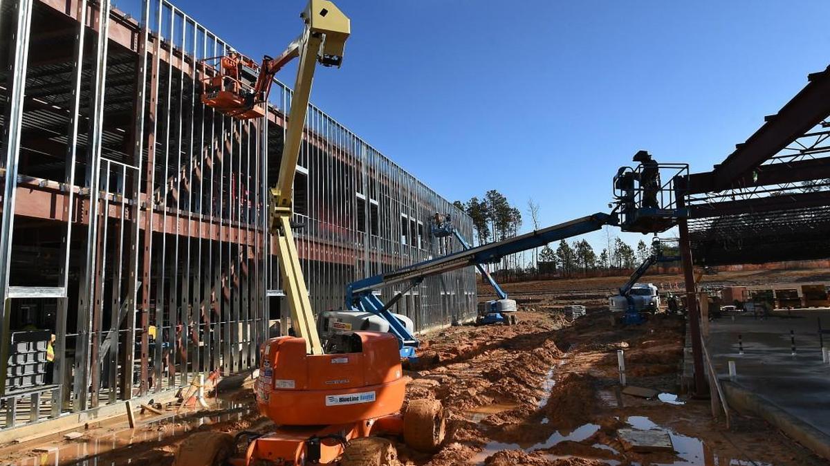 Workers use lifts to work on various areas at the new Oakview Elementary School Tuesday, December 8, 2015 in Holly Springs, N.C.