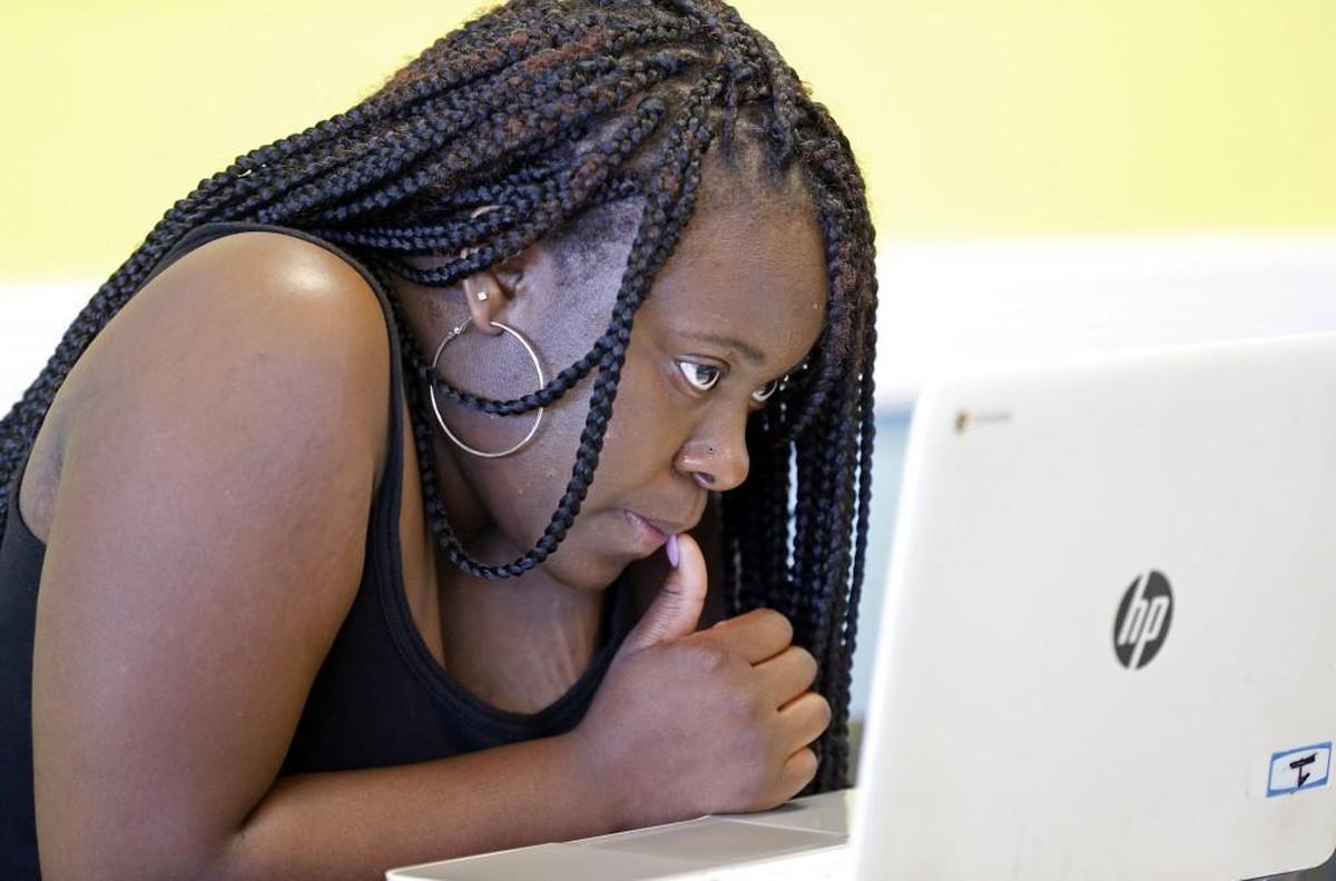 Student Chamonta Artis bears down as she works on an English lesson at the Wake Acceleration Academy in Garner on Tuesday. Friday marks the last day for a two-year old program that helped dozens of Wake County high school students, many of whom had been dropouts, get their diploma. The Wake County school system plans to start its own dropout recovery academies so it's ending its relationship with a for-profit company that ran the program.