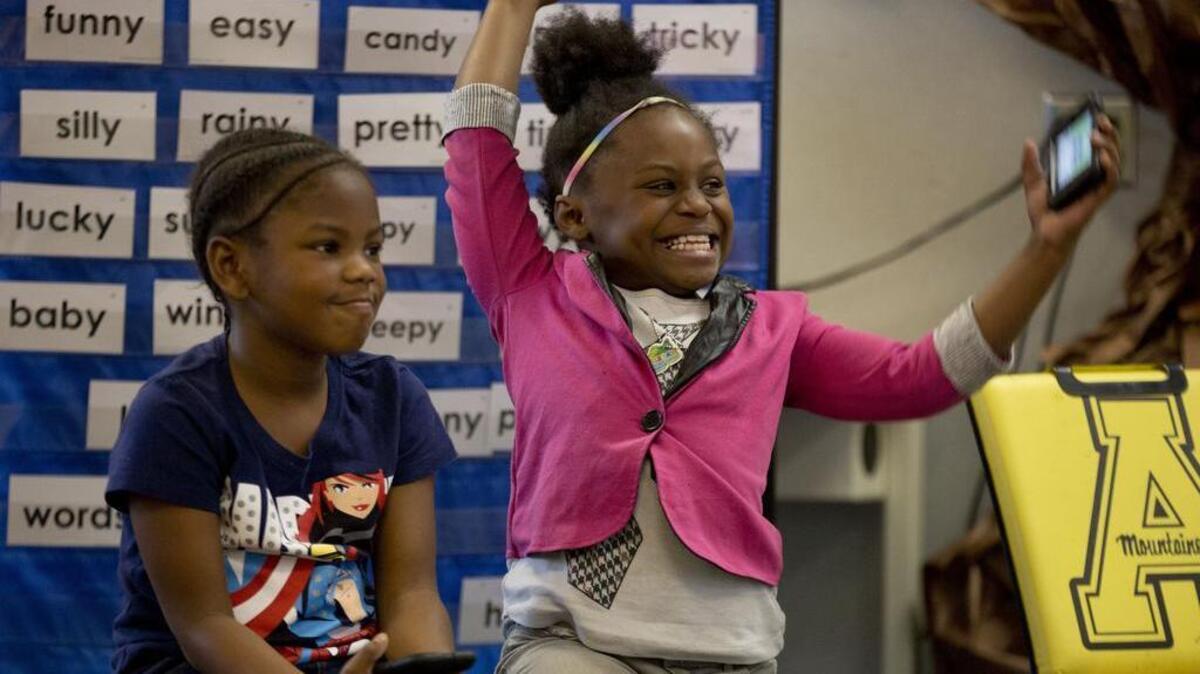 From left, first grade students Trinity Sessoms, 7, and Christi Freeman, 7, participate in a classroom phonics game played on iPods at Barwell Road Elementary School on Thursday, May 12, 2016, in Raleigh, N.C.