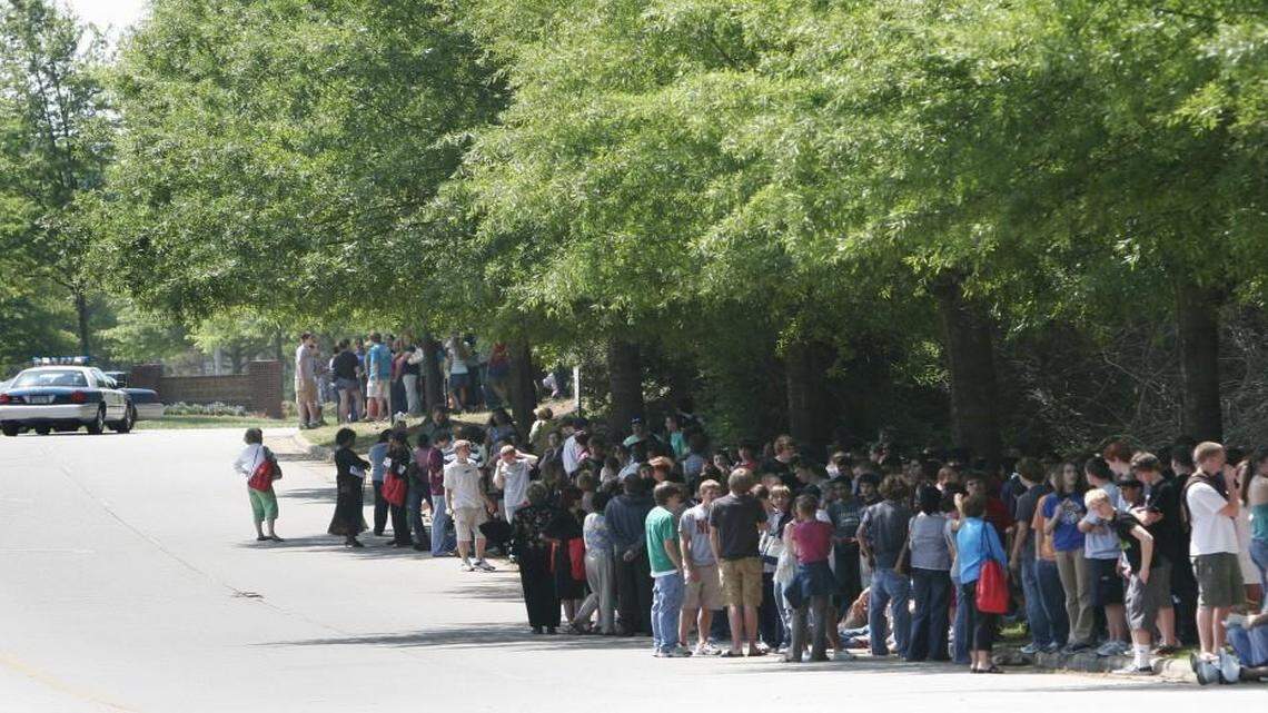 Leesville Road Middle School and High School students, teachers and administrators crowd the road outside the schools during an evacuation prompted by a bomb threat on April 25, 2007. Wake County is considering fining and suspending students who make threats that lead to evacuations.