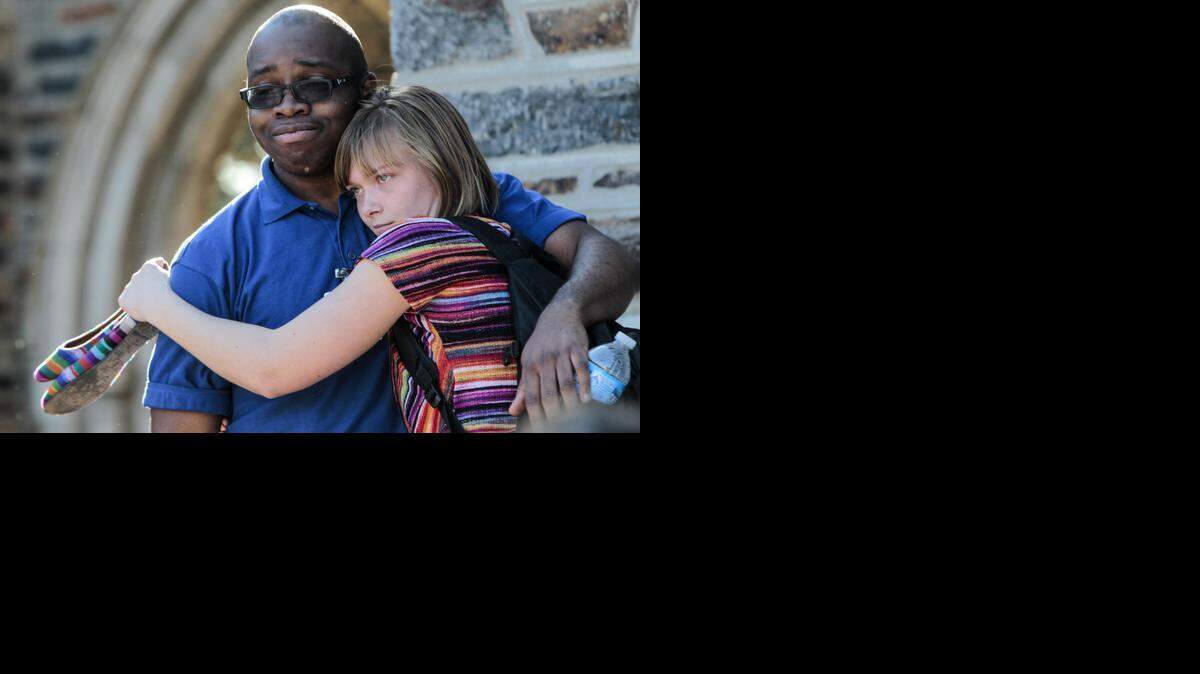 
Duke students Levi Edina Obama and Anna Marie Keppel-Benson embrace following a university-wide forum Wednesday, April 1, 2015, outside Duke Chapel on Duke University’s campus in Durham, N.C., after a noose was discovered hanging from a tree outside a student center on campus.
