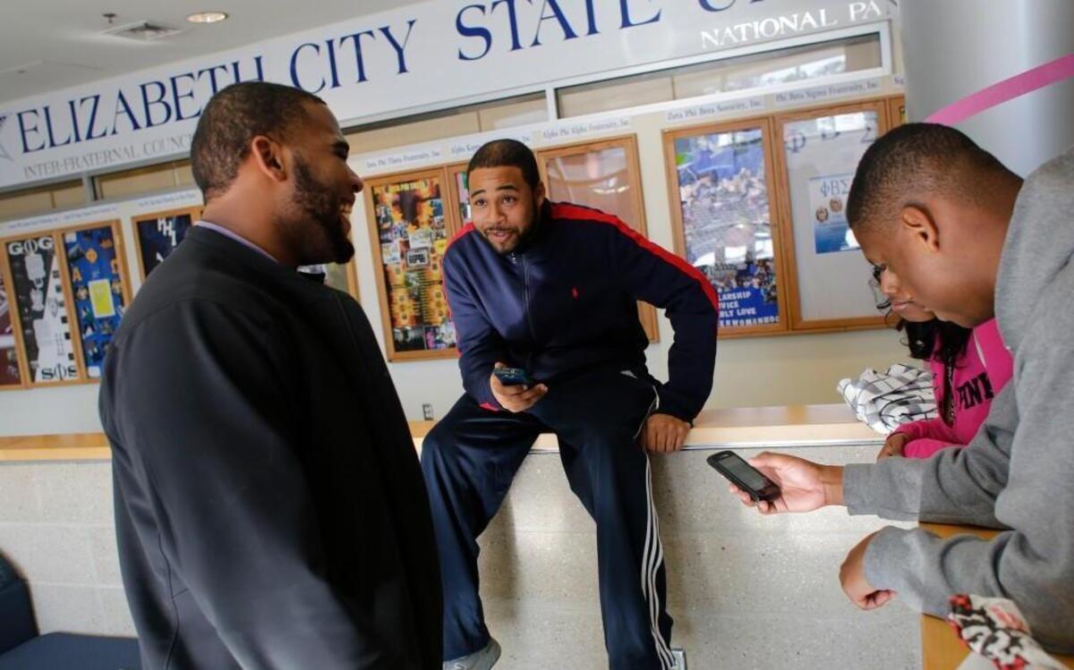 From left, Jonathan McPherson, Terrence Raycrow, Karishma Appadu, and Julian Davis socialize between classes Tuesday, January 21, 2014 at Elizabeth City State University's Ridley Student Center.