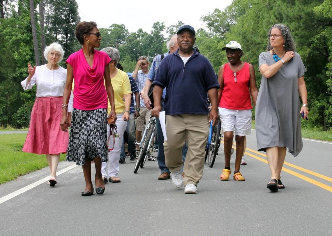 From left, state Sen. Ellie Kinnaird, Orange County Commissioner Renee Price, neighborhood activist the Rev. Robert Campbell and Chapel Hill Town Council member Penny Rich walk down Eubanks Road to celebrate the closing of the Orange County Landfill on Saturday, June 29, 2013, after about 40 years. Residents in the historically black Rogers Road neighborhood fought repeated extensions, citing noise, odor, traffic and vermin.