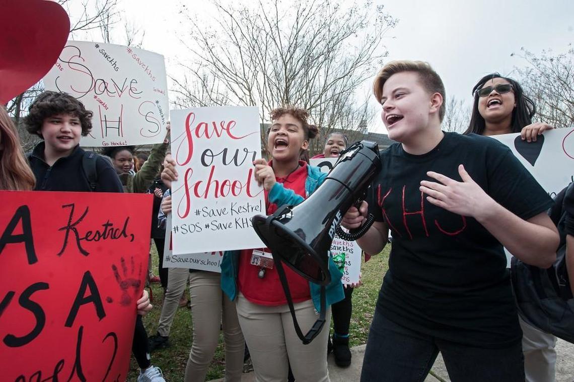 Kestrel Heights High School junior Faye Gant, right, leads the crowd in chanting during a "Save Our School" rally on Jan. 31, 2017 in Durham, amid controversy over students who graduated from the school without meeting state graduation requirements.