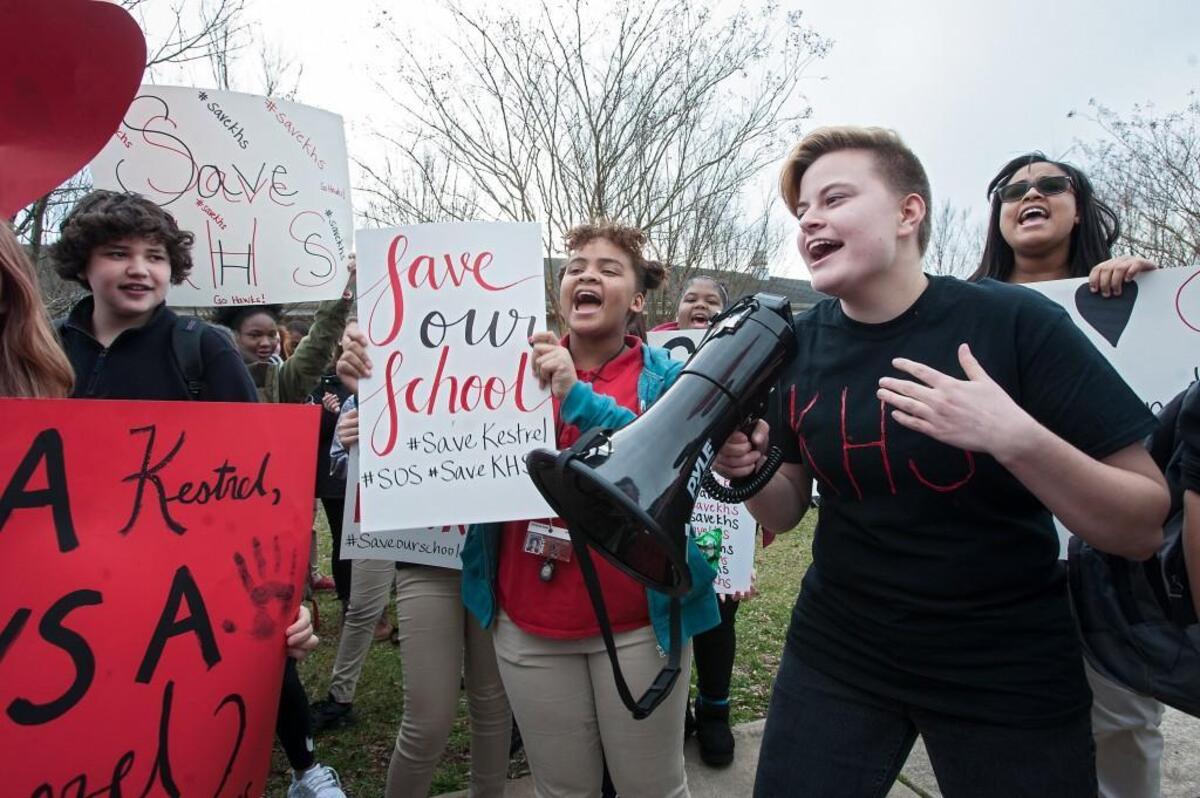 Kestrel Heights High School junior Faye Gant, right, leads the crowd in chanting during a "Save Our School" rally on Jan. 31, 2017 in Durham, amid controversy over students who graduated from the school without meeting state graduation requirements.