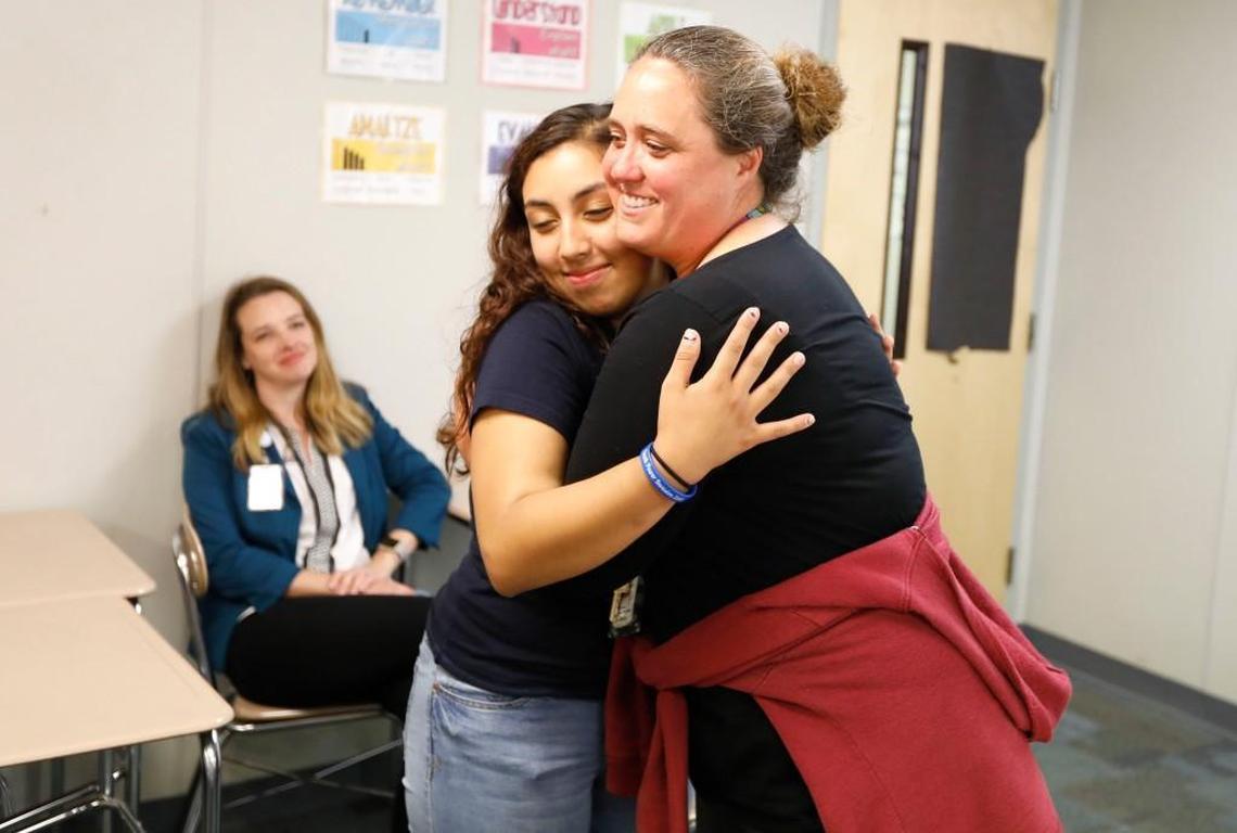 Megan Walter gets a hug from student Emily Paz after Walter was named Wake Countyâ’s 2017 School Counselor of the Year during a surprise ceremony at Wakefield High School in Raleigh, N.C., on May 24, 2017. The school system may to help close a budget shortfall this year by reducing a plan to spend $10 million on more counselors and social workers.
