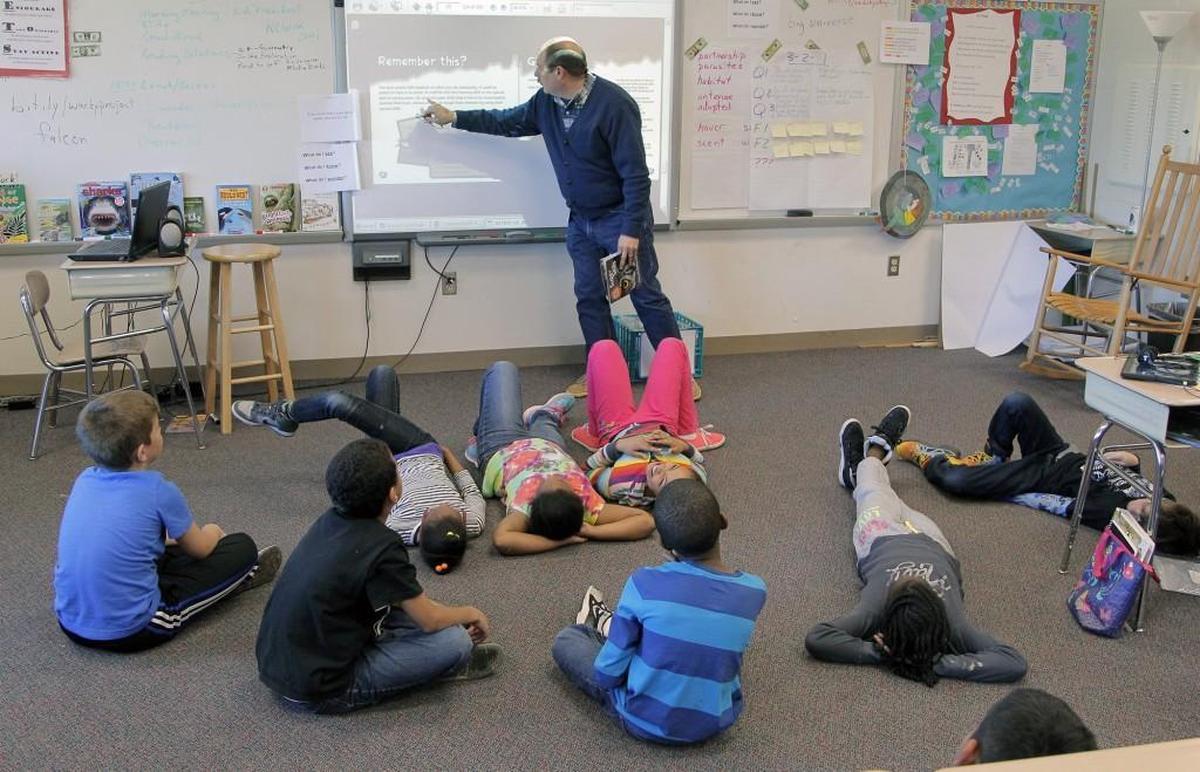 Jeff Maynard, center, teaches a reading lesson to his third-grade class at Brier Creek Elementary School in Raleigh on March 13, 2014. The students worked in “reading camps” to prepare for end-of-grade tests to comply with with Read To Achieve.