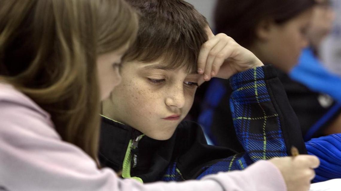 Mackenzie Geiger explains her thinking to Cameron Tormone on a math problem in Dana Snapp's class at Fuquay-Varina Elementary School. Students there have been using Common Core Math for the past four years.