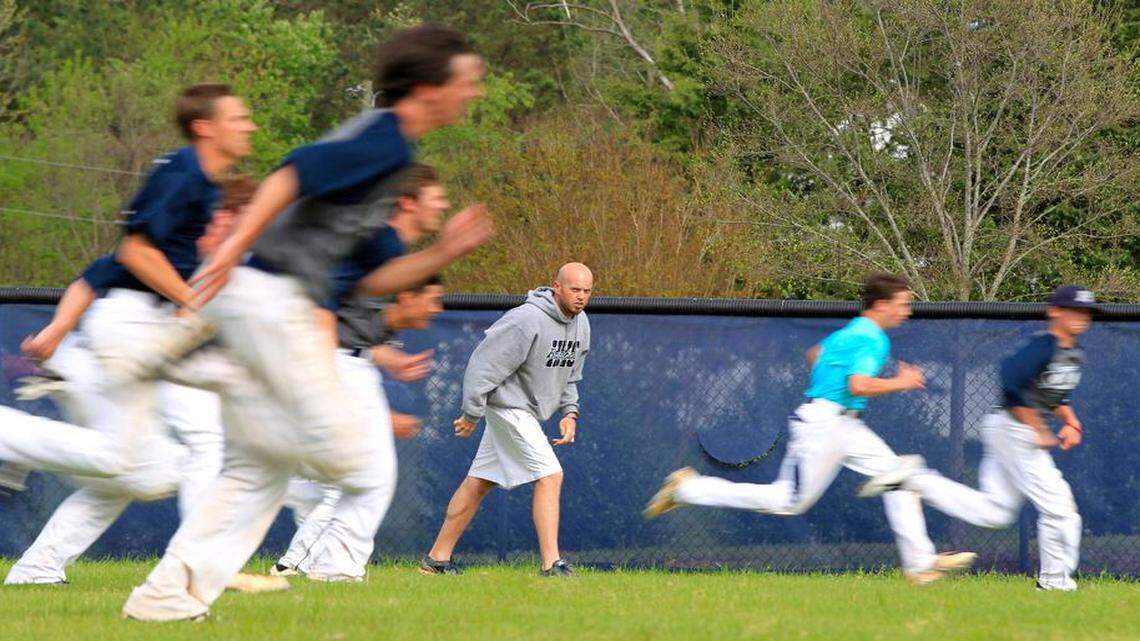 
Thomas Ferrara, the JV baseball coach at Heritage High School in Wake Forest, watches his team during practice on Thursday. Teachers who perform extra work such as being athletic coaches, academic coaches, band directors and department chairs could receive an increase in their stipend.

