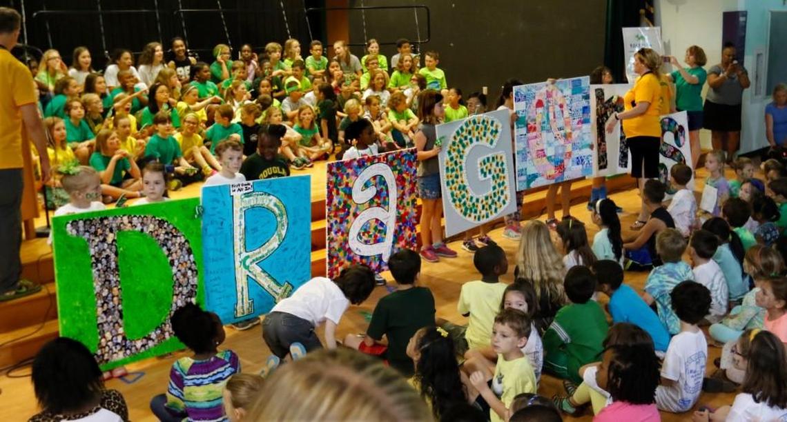 Douglas Magnet Elementary School teachers help students holding the giant letters for the school's mascot, DRAGONS, at the start of a school celebration with students, staff and parents on May 13, 2016 honoring Douglas as being named best magnet school in the nation by Magnet Schools of America.