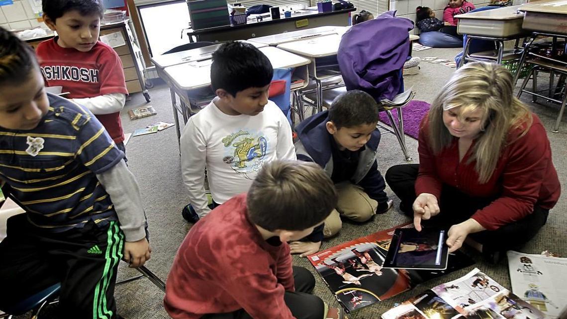 Second Grade Teacher Kathy Etheridge, far right, works with some of her 23 students, including Kyle Burgess, in foreground, Daniel Gomez-Cervantes, white shirt and Caleb Leach, second from right, during a small-group reading time at Vance Elementary School on Feb. 5, 2015.