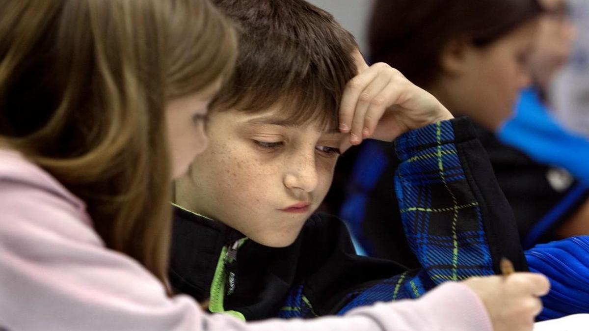 Mackenzie Geiger, left, explains her thinking to Cameron Tormone on a math problem in Dana Snapp's class at Fuquay-Varina Elementary School. Students there have been using Common Core Math for the past four years. School administrators say it is working for both the students and teachers, while some parents are looking to get rid of it. Rene Herrick, teacher leadership specialist in mathematics at the school, not seen, says the system is important to keep in place.