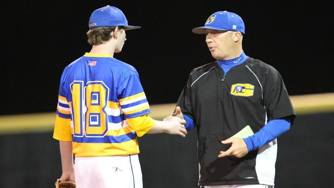 Garner High School baseball coach Derik Goffena talks to Garrett Capaforte (18) during the game with East Wake High School in Wendell, N.C., on March 24, 2017. The Wake County school system may delay this year’s raises for extra-duty pay to help balance the budget.
