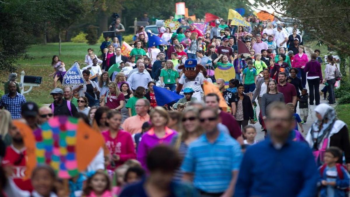 
Wool E. Bull joins hundreds of students and families from A.B. Combs as they walk down Ashburton Road during the National Walk to School Day on Wednesday October 8, 2014 in Raleigh, N.C.
