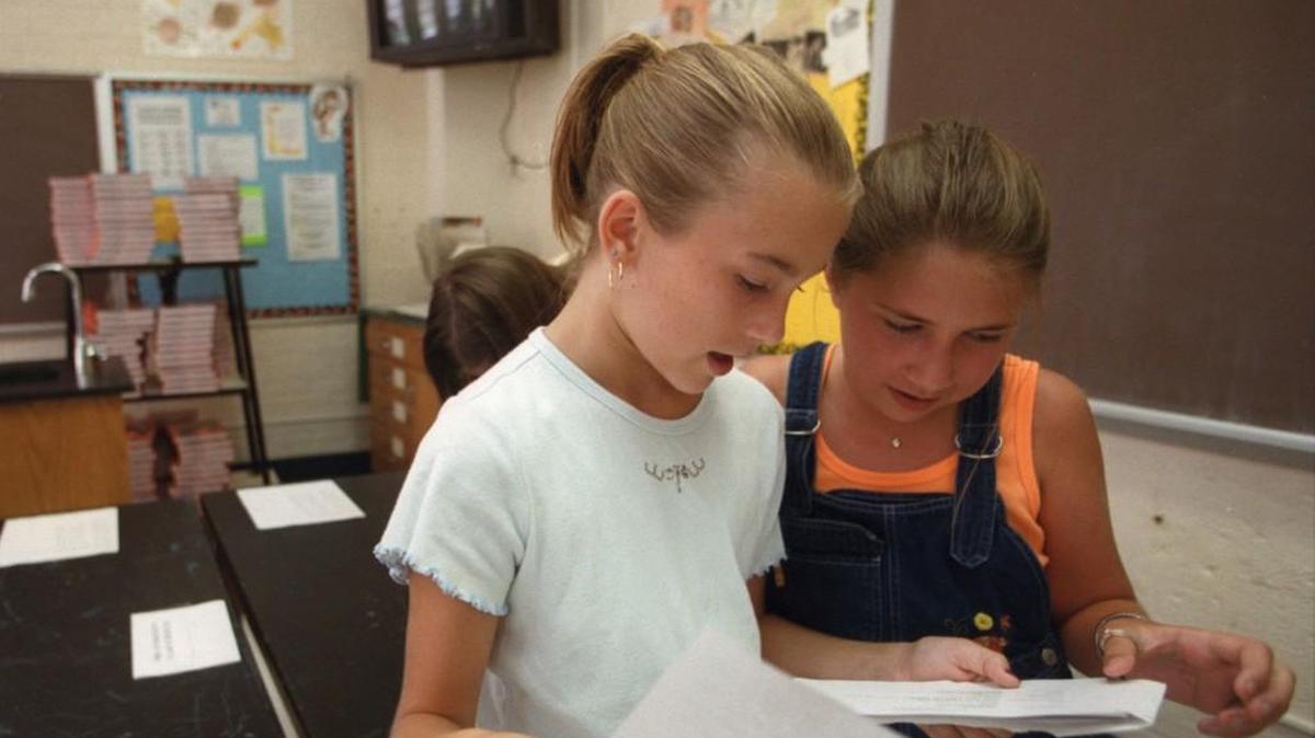 Two sixth-grade students at Fuquay-Varina Middle School look over their schedules to see if they have any of the same classes in this file photo. Fuquay-Varina Middle is among several schools affected by a proposal to reassign students to put more families on the same calendar from elementary school through middle school.