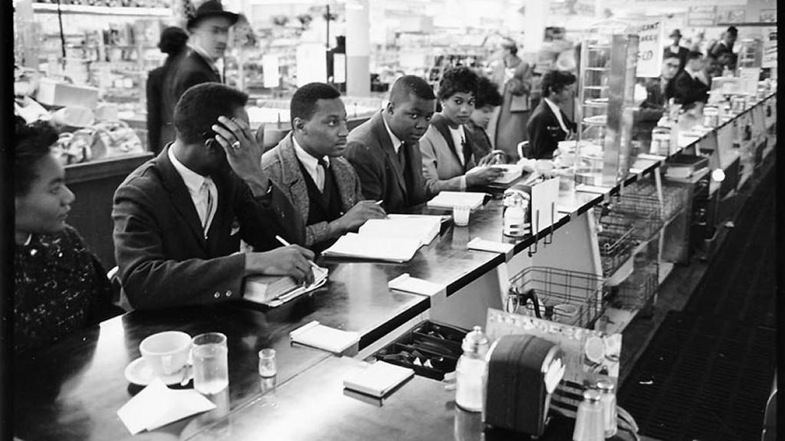 Students stage a "sit-in" protest organized by SNCC, the Student Nonviolent Coordinating Committee at Raleigh's F.W. Woolworth in February 1960. SNCC was founded at Shaw University in 1960.