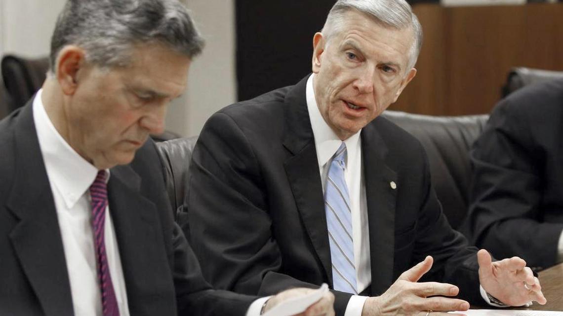 Outgoing UNC System president Tom Ross, right, sits with UNC Board of Governors chair John Fennebresque, left, during a press conference in January.