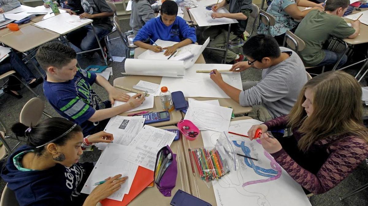 Rolesville Middle School students (L:R) Michaela Brown, Julian Stinnett, Armani Rodriguez, Pedro Hernandez and Kaitlin Seagraves work on an assignment in Mary Nelson's Common Core Math 7 Plus class at the school on Feb. 21, 2014.