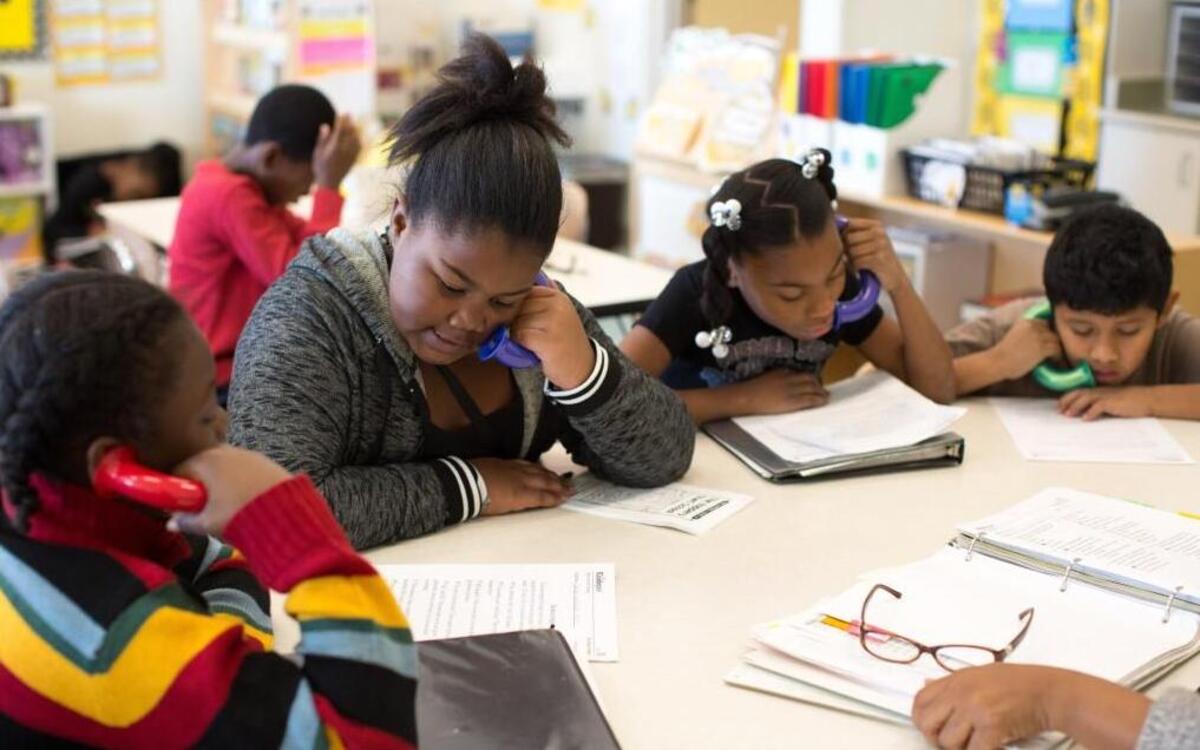 From left, Jerry Crisler, 9, Aniya Pettiford, 10, Aniyah Alford, 10, and Miguel Candela, 10, use 'whisper phones' to listen to themselves read out loud during writing and reading in their fourth grade class at Walnut Creek Elementary School on Monday, Jan. 11, 2016 in Raleigh. Walnut Creek is one of nine elementary schools that could switch to the year-round calendar in 2016.