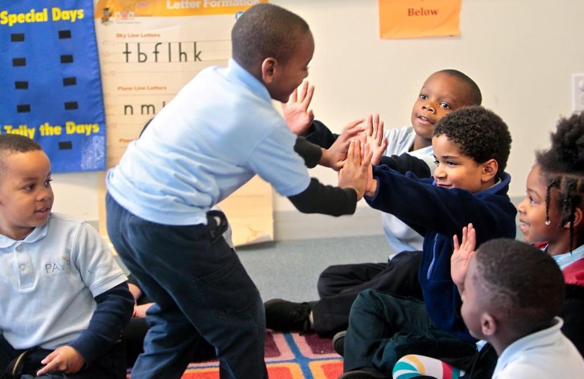 Supporting one another during a lesson on poet Langston Hughes, (from left) Jhi'Mir Carter, Kayden Marbury, Josiah Smith, Amir Qadir, and Jazlyn Turay participate in Lydia Cuomo's Kindergarten classroom at PAVE Southeast Raleigh Charter School on February 17, 2016. A new report from the Fordham Institute says that despite the large number of charter schools in Wake County there are several high-poverty neighborhoods that don't have charter elementary schools.