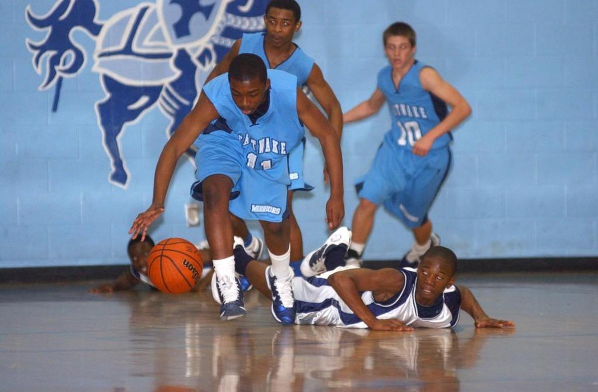 East Millbrook Middle School players hit the deck after East Wake Middle’s Brandon Cameridge (11), Thomas Jones and Nick Pope (10) force a turnover in Wednesday’s conference championship game in Knightdale in 2011. The State Board of Education is considering new mercy rules for middle school sports in North Carolina.
