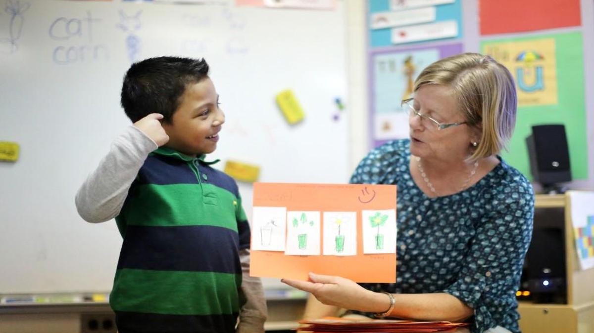 Oziel Vargas-Mendez, 5, reads a story to his pre-kindergarten class with the help of his teacher Jean Evans on Friday, March 28, 2014 at Hilburn Academy in Raleigh, N.C.