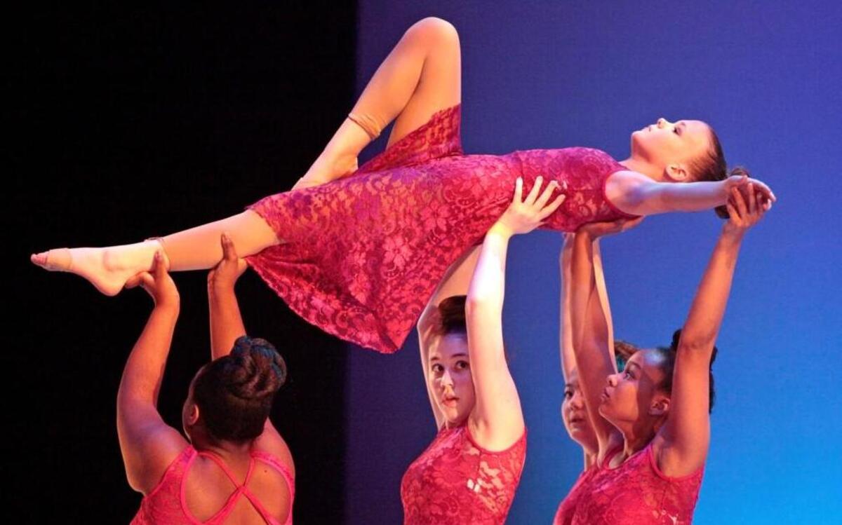 Dancers from Moore Square Middle School hold up a colleague during their Act 1 dress rehearsal dance at the Duke Energy Center for the Performing Arts on March 8, 2016.