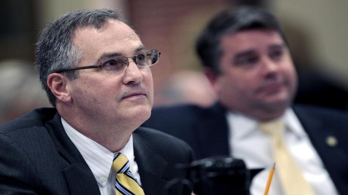 UNC Board of Governors working group members Steven Long, left, and James Holmes listen to staffers from UNC’s Center for Civil Rights respond to Long’s questions during a 2014 hearing.