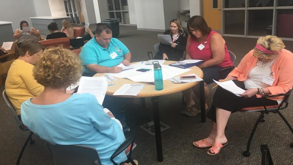 Wake County teachers read about how to develop culturally relevant lessons during a training session at Vernon Malone College and Career Academy in Raleigh on July 26, 2017.