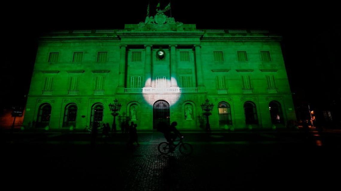 The City Hall of Barcelona is illuminated in green last week to protest U.S. President Donald Trump’s decision to take the United States out of the Paris climate accord.
