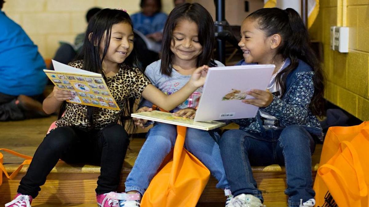 From left, Kelly Morales, 7, Leslye Monterroza, 6, and Joselynne Serrano, 6, read through books donated through the WAKE Up and Read Book Drive during a book fair at Fox Road Elementary School in Raleigh on May 2, 2016. The State Board of Education voted Thursday, Dec. 1, 2016, to allow Fox Road and 18 other struggling schools to operate more like charter schools.
