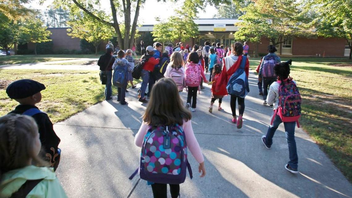 Students at Helen Y. Stough Elementary in Raleigh arrive at the school in the morning of Oct. 4, 2011. The Wake County school system is considering whether to do a mix of new construction and partial renovations at Stough or to demolish what exists in favor of all-new construction.