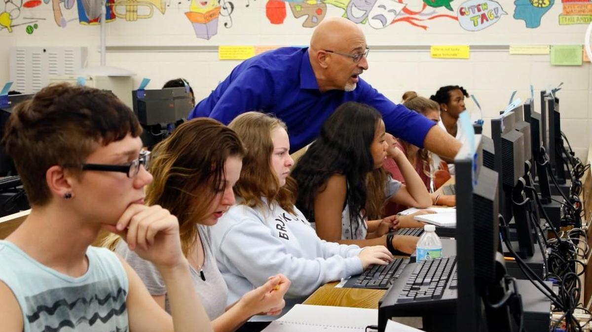 Credit recovery class instructor Mike Bellissimo, standing, helps students, grades 9-12 focus their online studies during the second half of their computer lab at Sanderson High School, Raleigh, NC on Sept. 1, 2016.