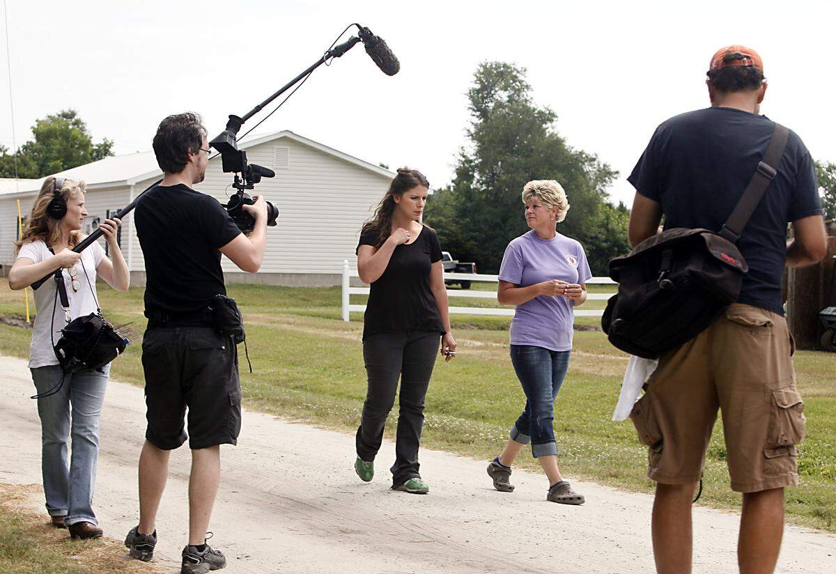 Chef Vivian Howard, center left, interviews farmer Christy Crumpler, of Brittany Ridge Farms, center right, while filming her PBS North Carolina show “A Chef's Life” in Hookerton, North Carolina, in 2014. 