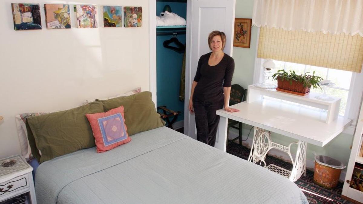 Allyn Meredith stands in the room she rents out in Durham on the Airbnb online platform. Meredith has been an Airbnb host since November 2011.