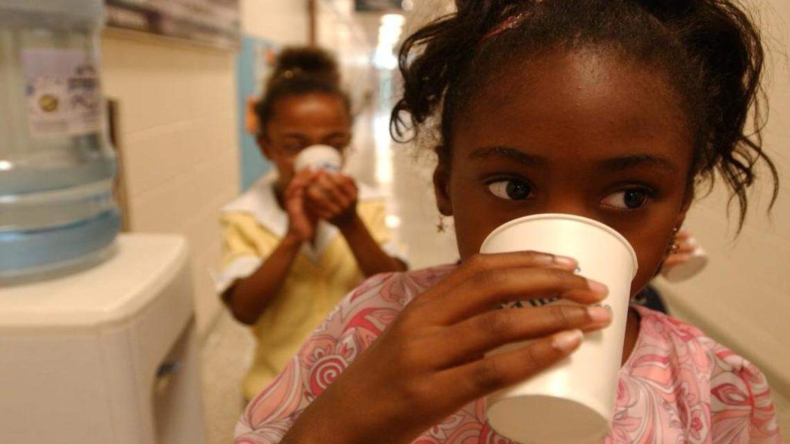 In this file photo, students at Y.E. Smith Elementary School in Durham drink bottled water from one of several water stations installed after a lead contamination problem was found in the school drinking fountains in 2004.