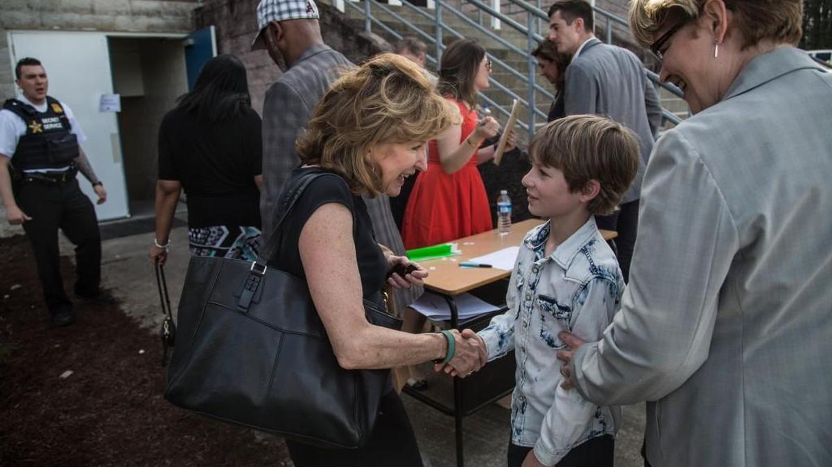 Former Sen. Kay Hagan shakes hands with 9-year-old William Popp prior to a campaign rally Thursday, March 10, 2016 at Hillside High School in Durham.