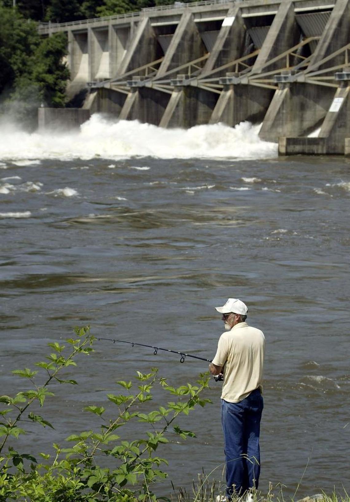 Tom Elliott of Kannapolis, N.C., fishes in the waters below the dam separating Badin and High Rock lakes near Blaine, N.C. The Alcoa Badin Works, shuttered for a decade, has sold this and three other massive hydroelectric dams that provided power for the works. But Alcoa remains a major presence in the valley, where it owns more than 9,000 acres of undeveloped land. The N.C. Wildlife Resources Commission and the LandTrust for Central North Carolina hope to raise between $10 million and $12 million to buy 4,700 acres from Alcoa.