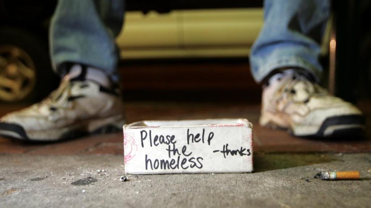 A box sits at the feet of Nathaniel Lee, 61, as he panhandles Oct. 27, 2005, on Franklin Street in Chapel Hill. After more than an hour of panhandling Lee collected a little more than a dollar.